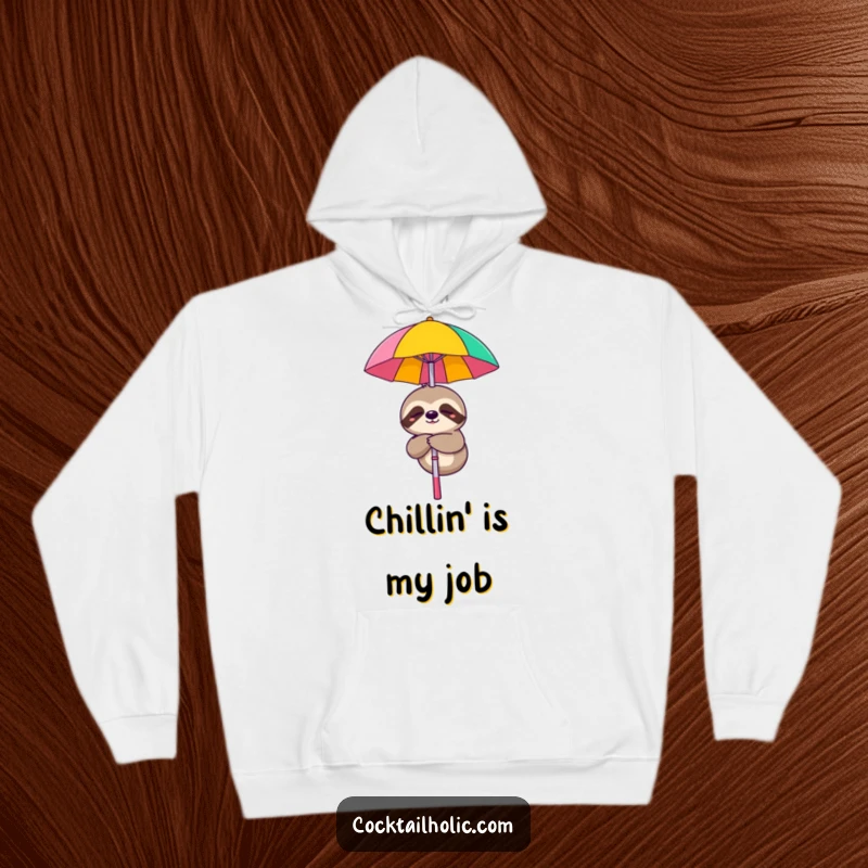 Funny hoodie with a sleepy sloth character smiling while hanging from a cocktail umbrella, a cozy choice.