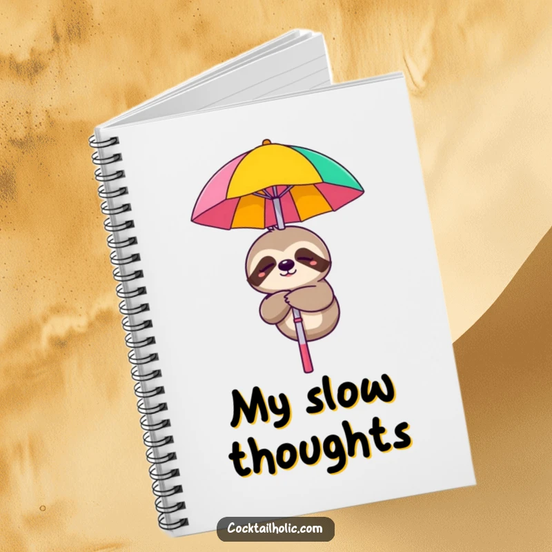 Funny notebook with a sleepy sloth dangling from a cocktail umbrella, perfect for jotting down slow ideas.